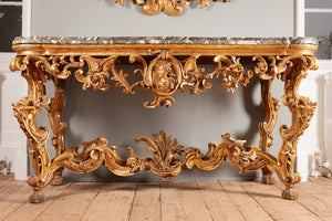an elaborately antique carved gilt wooden console table with a green marbled top