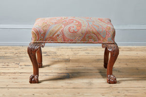 stool with paisley upholstery and clawed feet