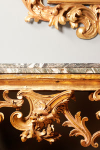 an elaborately antique carved gilt wooden console table with a green marbled top