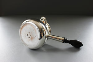 a silver saucepan with a wooden handle