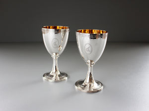 silver wine goblets with a gold interior and floral etchings