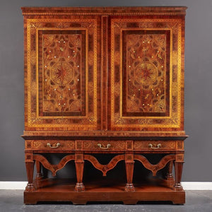 a wooden cupboard with elaborate florals marquetry