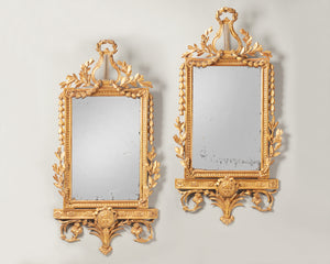 pair of carved gilt mirrors with lyre detail on top
