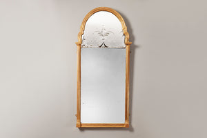 gilt framed mirror with an arched top