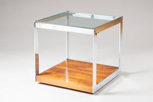 a glass topped side table with wooden lower shelf and chrome frame
