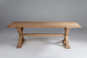 a dark wod dining table with x-shaped legs